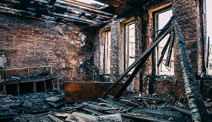 burnt room interior with walls furniture and floor structural fire damage