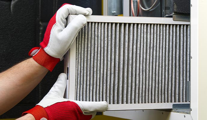 expert replacing HVAC filter.