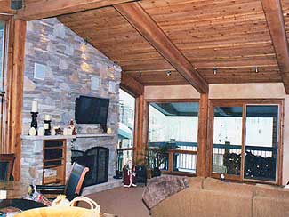 Living Area with Balcony and Stone Fireplace