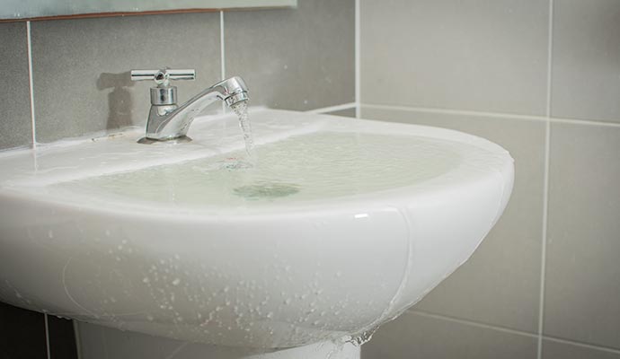 water damaged bathroom for sink overflow